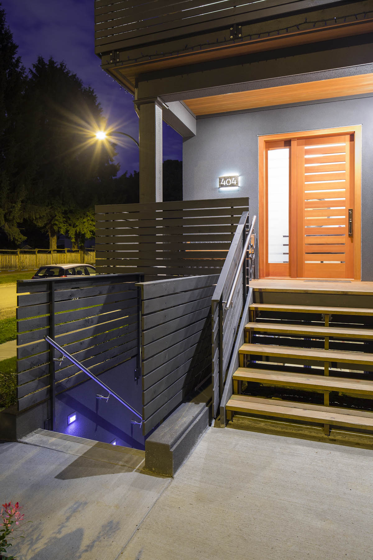 Back entrance with wooden stairs and door at the West Vancouver custom home.