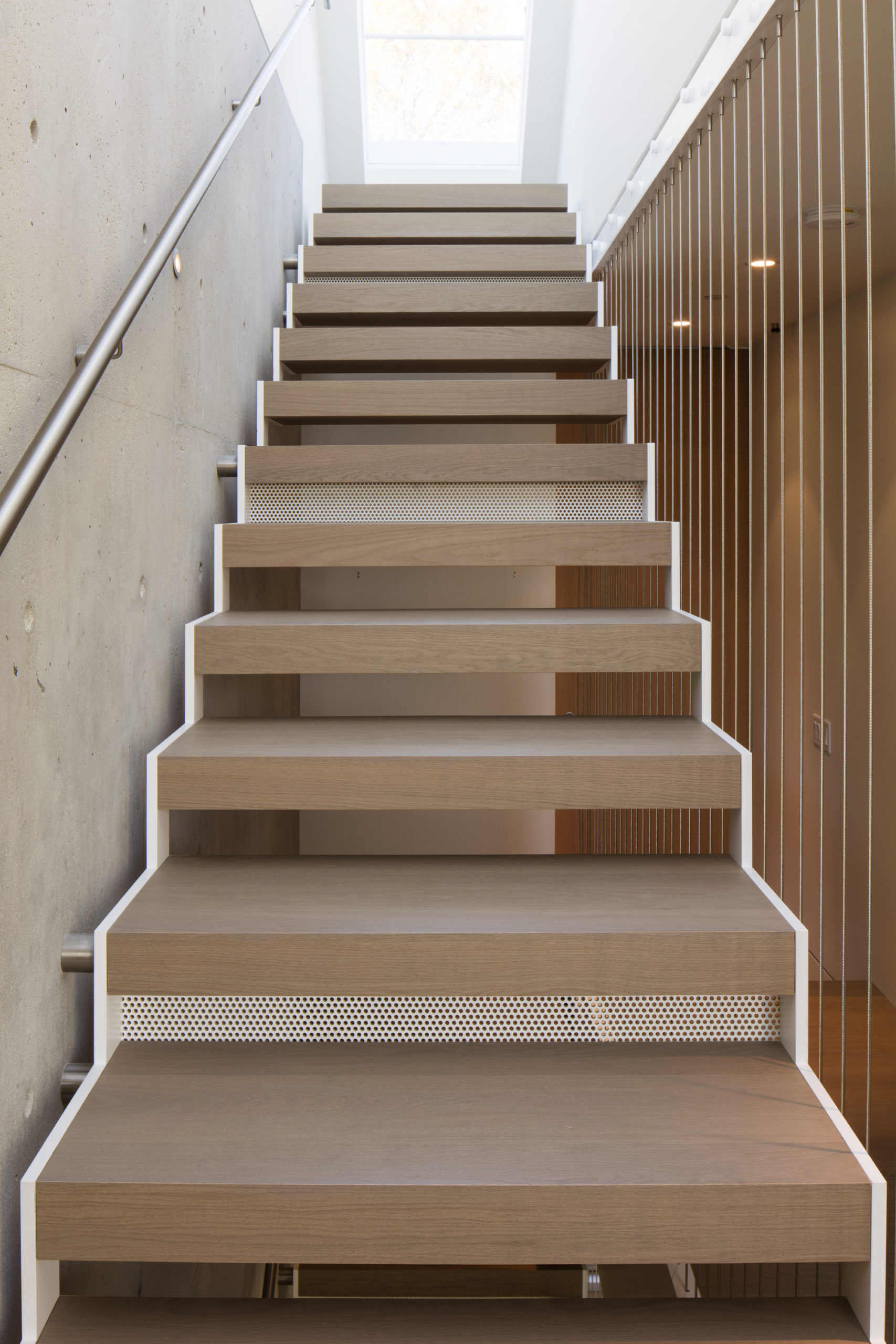 Contemporary stairs with a minimalist design at a custom home in Vancouver.