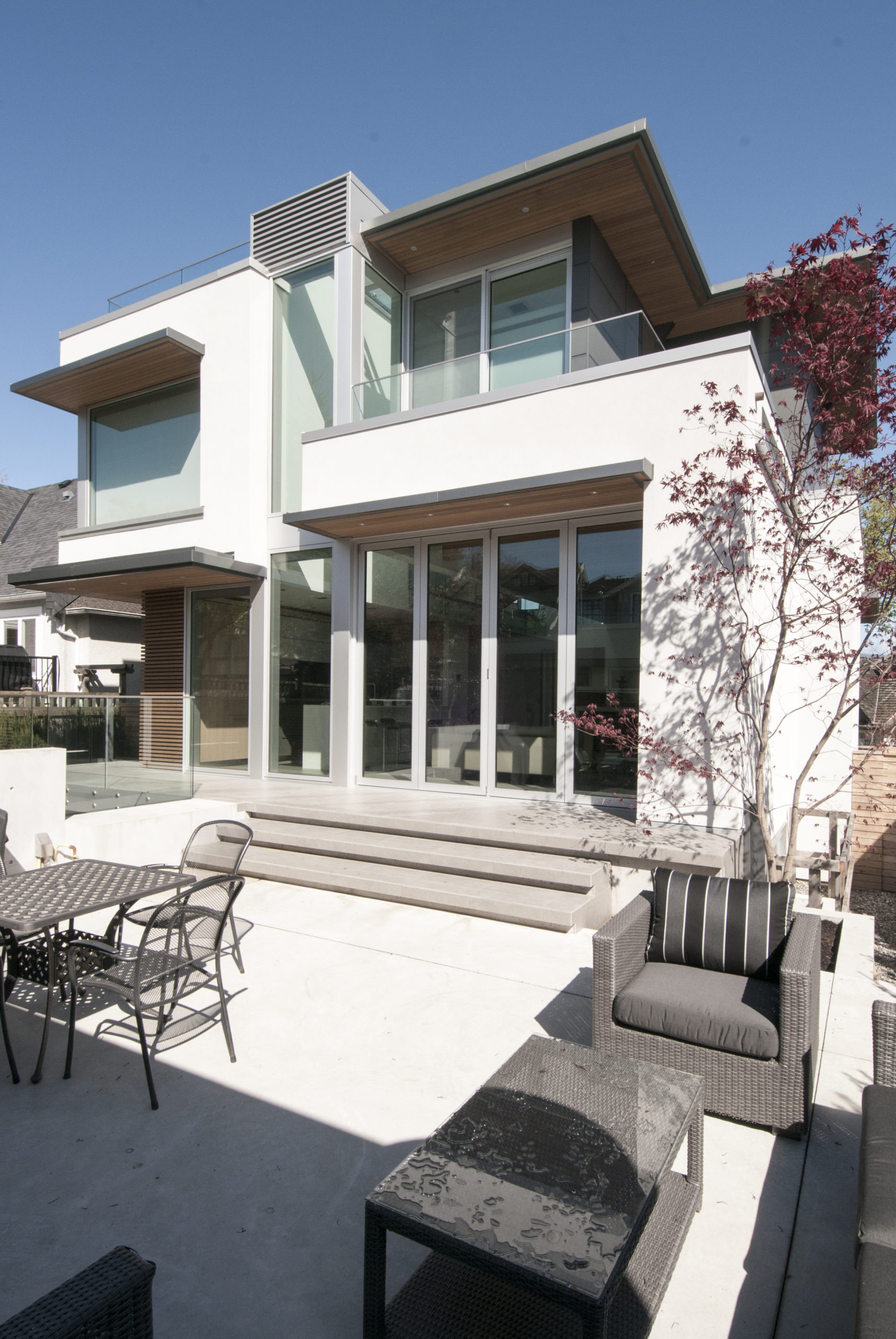 Spacious backyard with a minimalist design at a Vancouver custom home.