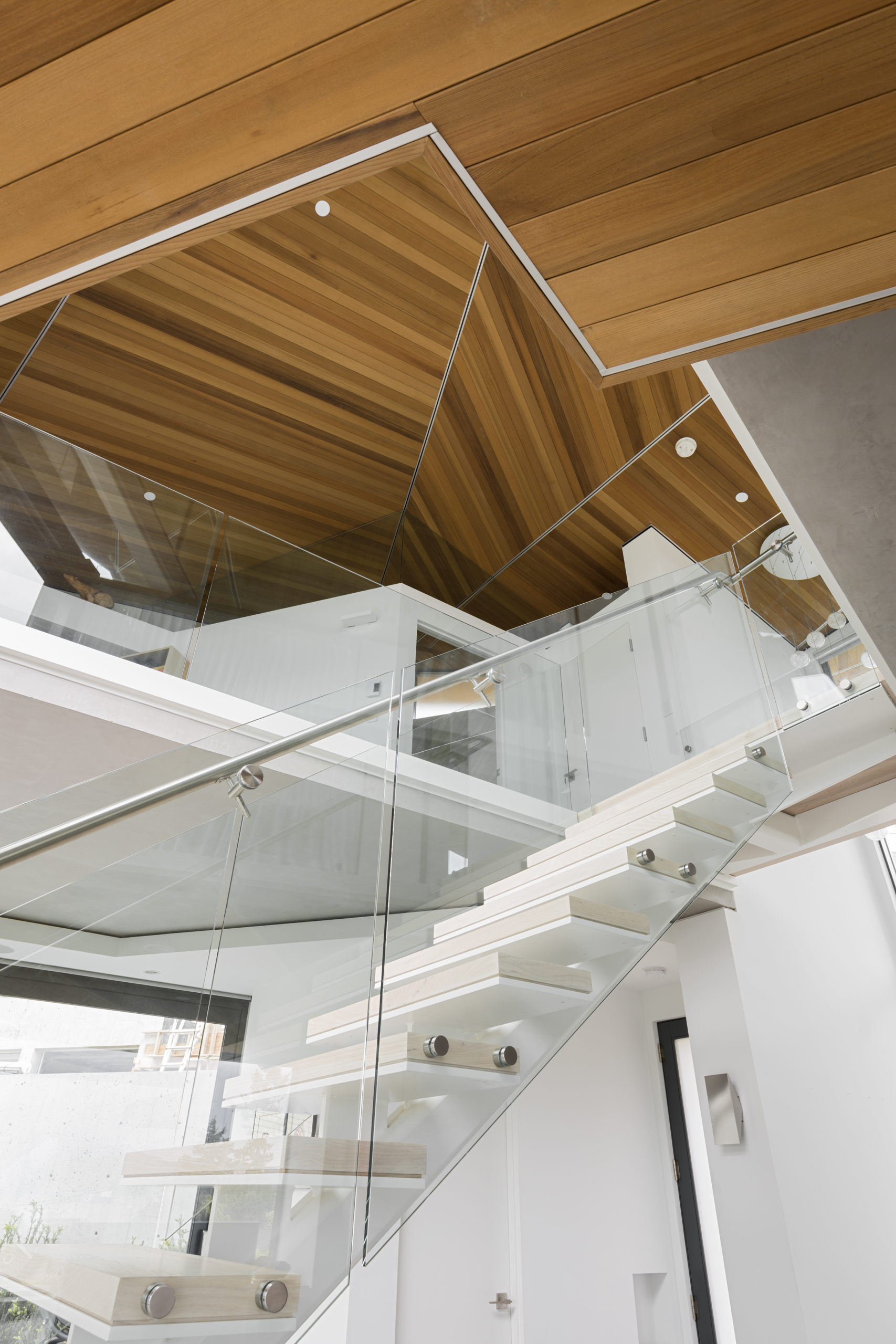 Glass-sided stairs with a modern design at a custom home in Spanish Banks.