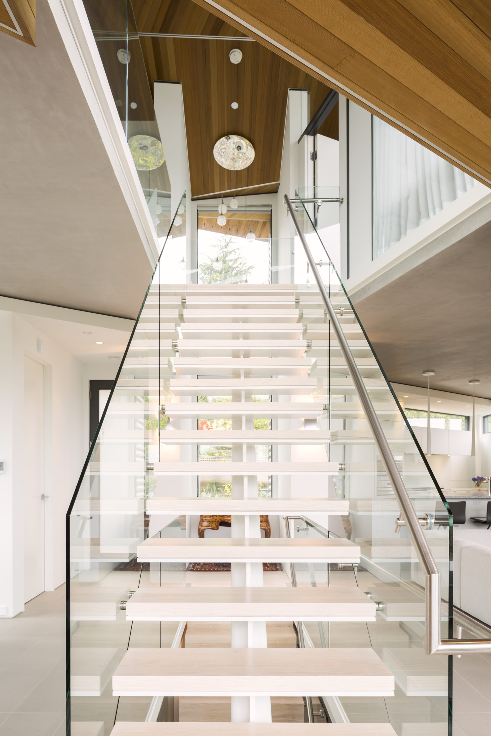 Glass-sided stairs with a modern design at a custom home in Spanish Banks.