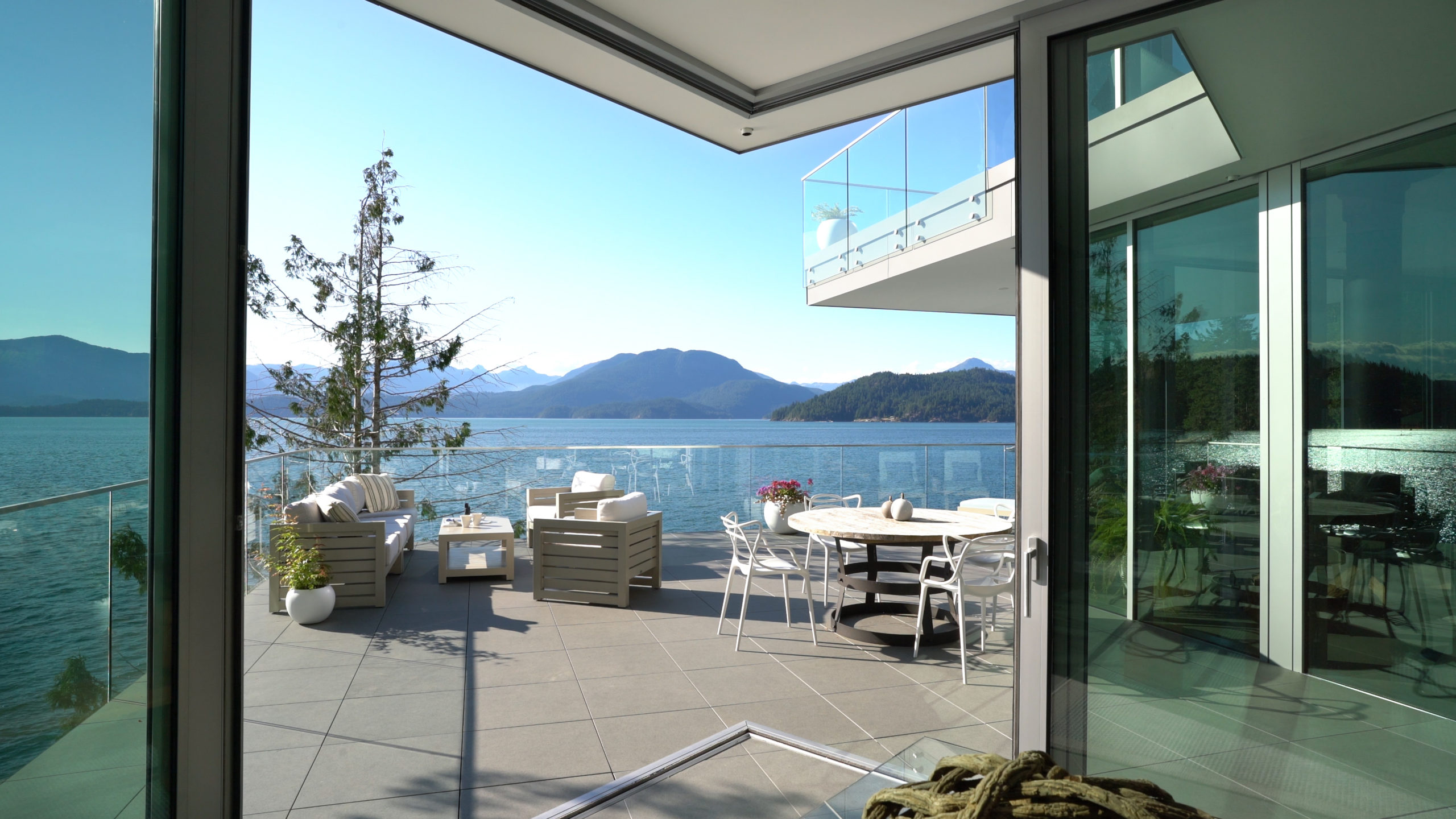 Spacious backyard with ocean view in a luxurious custom residence on Bowen Island.