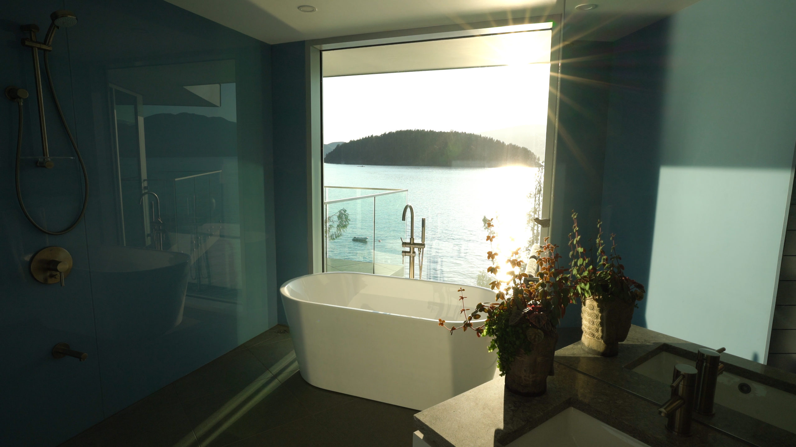 Shower and bathtub with an ocean view in a luxurious custom residence on Bowen Island.