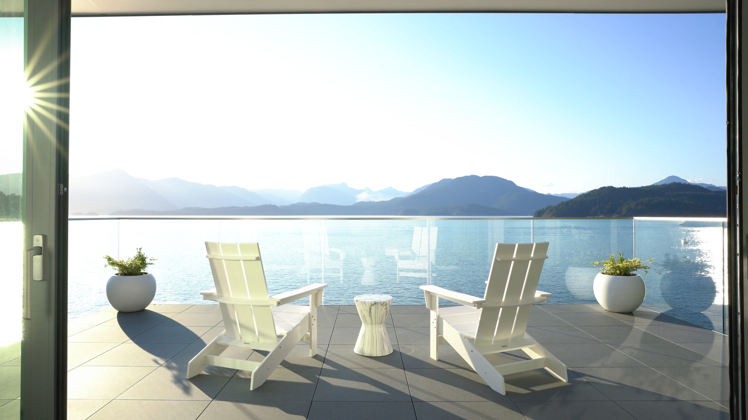 Balcony with minimalist design and ocean view in a custom residence on Bowen Island.