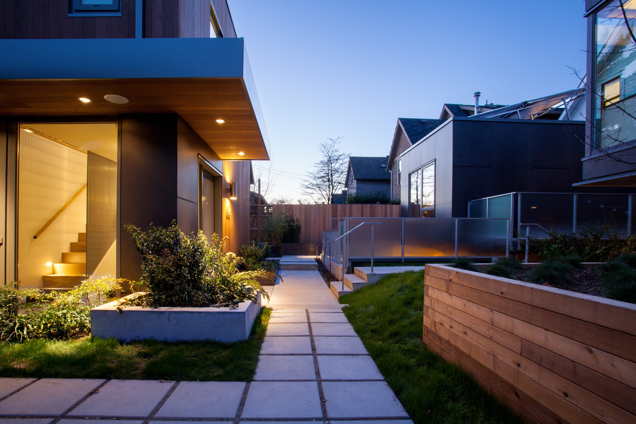 Exterior design with minimalist details at a custom multifamily home in Strathcona.